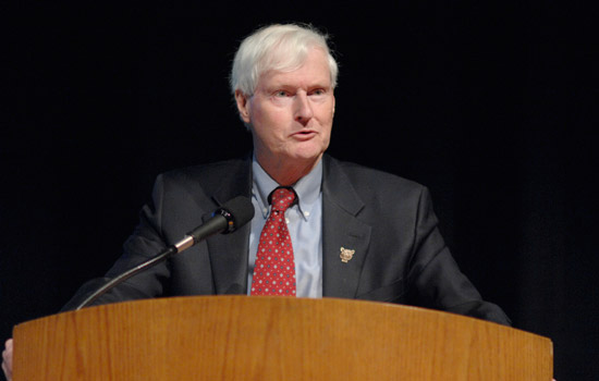 RIT President Bill Destler speaking at a podium.