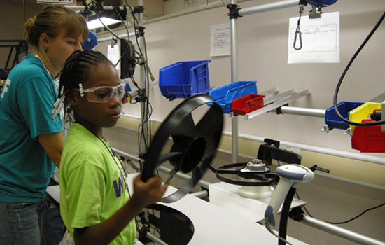 Students looking at car parts