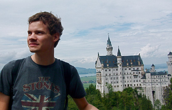 Person posing in front of castle