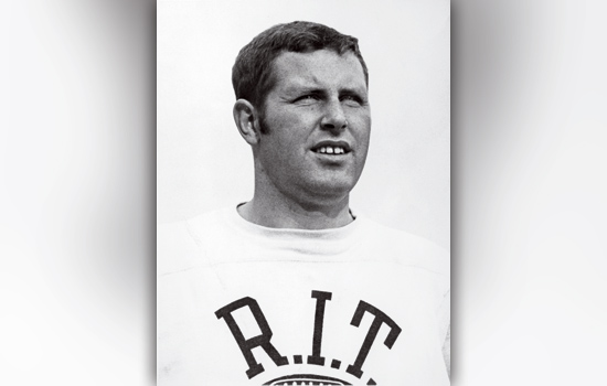 vintage picture of tom coughlin wearing rit sweater.