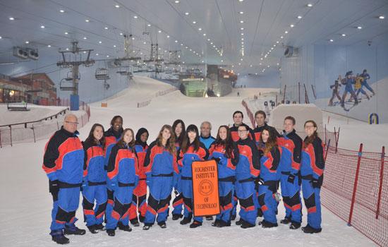 People posing in front of indoor ski hills