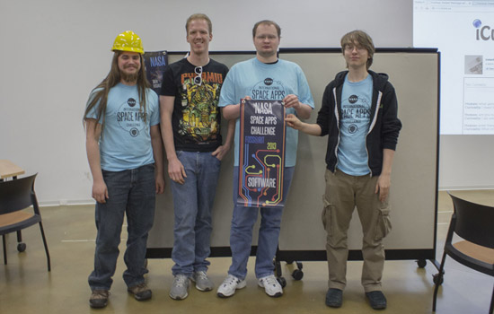 People posing at event with award