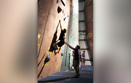 Person climbing up wall