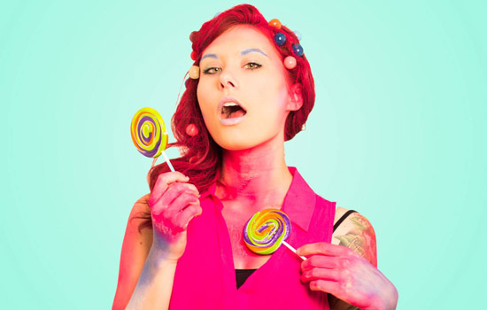 Person posing with lollipops