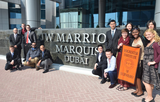 People posing near sign