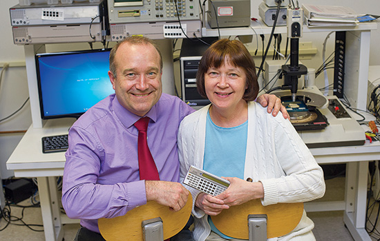 Two people posing in lab