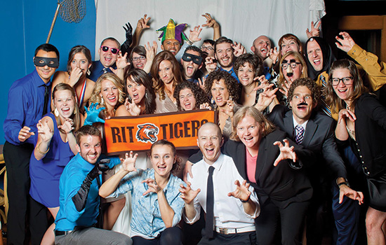 People posing with banner at event