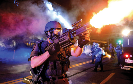 Person firing weapon at night