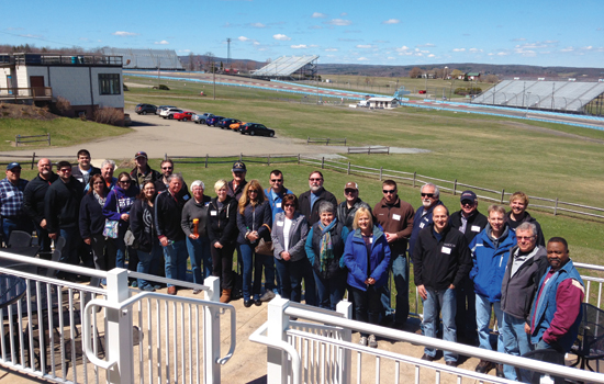 People gathered for picture at racetrack