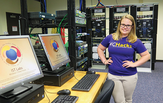 person standing next to computers.