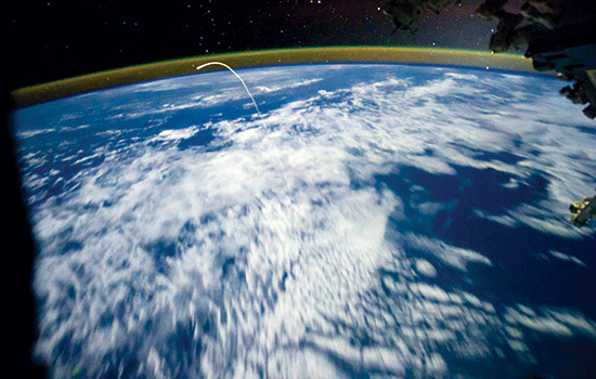 aerial earth image of space shuttle re entering earth atmosphere.