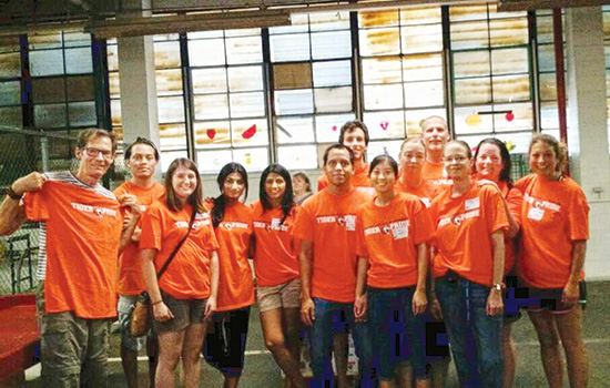 group of alumni wearing orange T shirts.