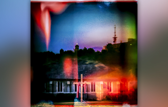 blurry photo of a cross in front of a building.