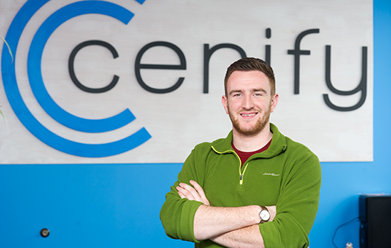 Alec Satterly poses in front of Centify company logo.