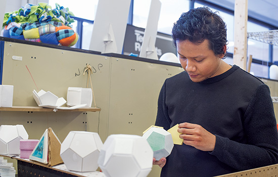 a person pealing a sticky note off of a sticky note ball