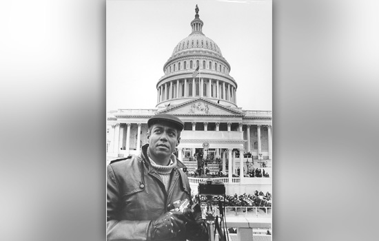 Person holding camera in front of United States Capital Building