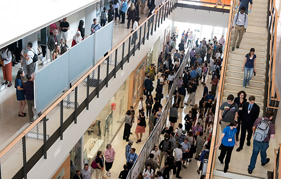 People gathered at event in busy class building