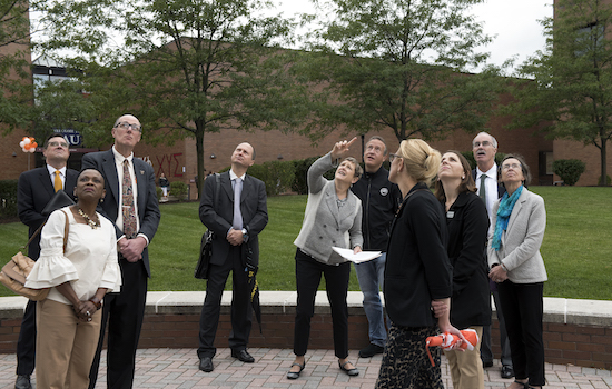 People visiting campus looking at sculpture