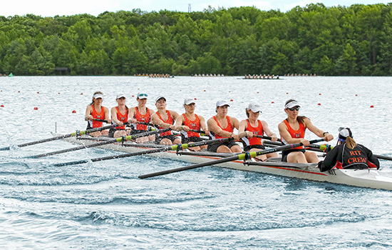  picture of women's crew team in boat.