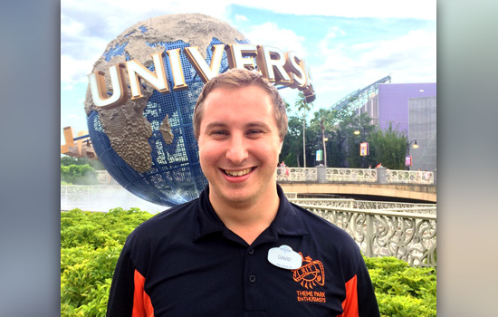 David Swerzenski smiling in front of Universal creative earth ball.