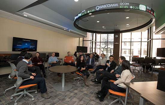  group of people sitting around tables in beijing business classroom.