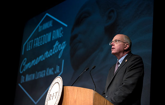 RIT President David Munson speaking at a podium.