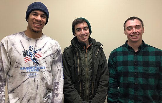 three people smile and pose for a photo.