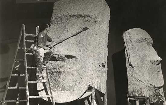 person working on easter island production statue.