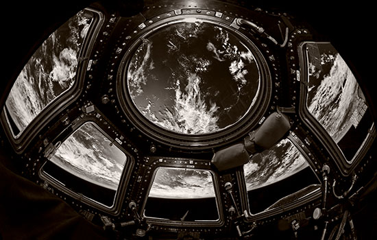black and white image of earth looking through space shuttle.
