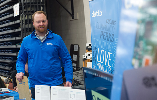 alumnus representing his company Datto at a career fair.