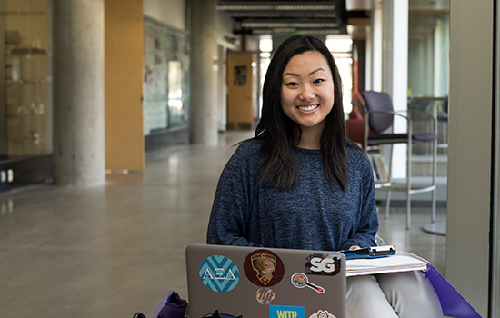 portait of Grace Yukawa sitting in front of laptop.