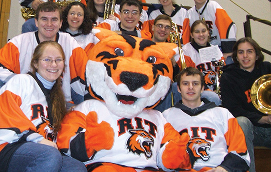 The original members of the 2006 RIT Pep Band posing for a photo with Ritchie.
