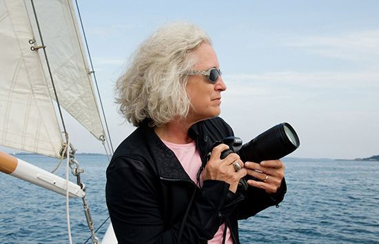  gail nogle holding a camera on a boat.