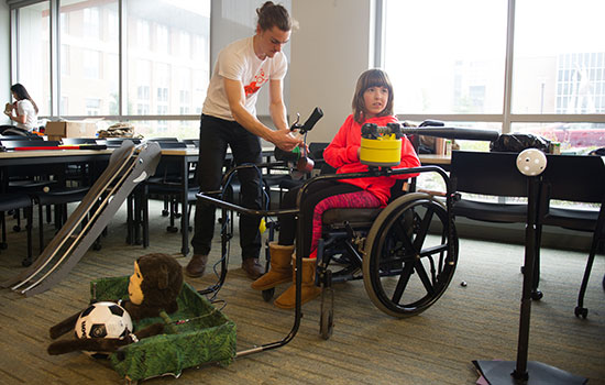 A person in a wheelchair testing various mechanisms.