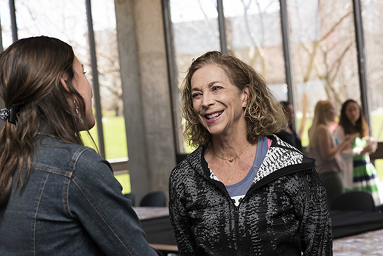  Keynote speaker, Kathrine Switzer, talking to another person.