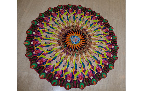 round colorful art piece on a tile floor.