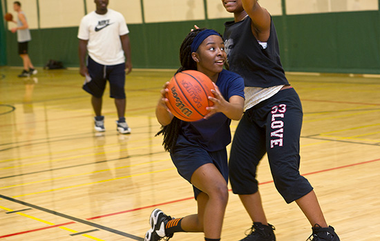 two people playing basketball in an action shot.