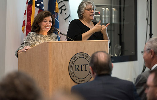 two people speaking at a podium.