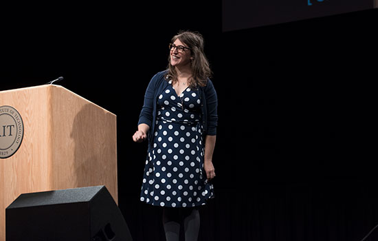 Mayim Bialik on stage next to RIT podium.