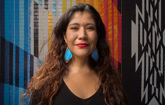  portrait of Tanaya Winder in front of a colorful wall.