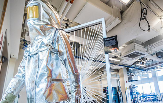 person in shiny lab suit in Golisano Institute for sustainability.