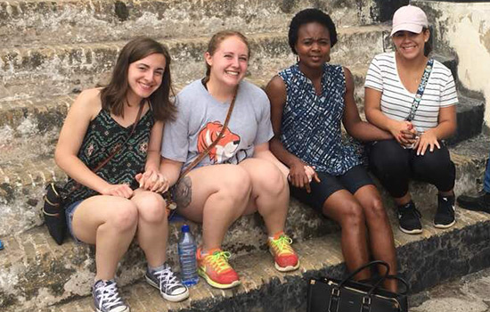  four students sit together for a photo in Ghana.