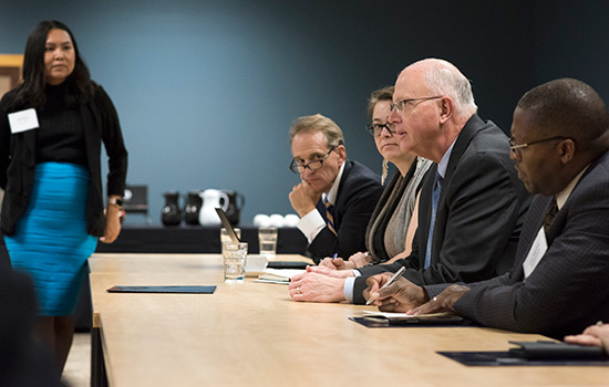 college administrators sitting at a table.